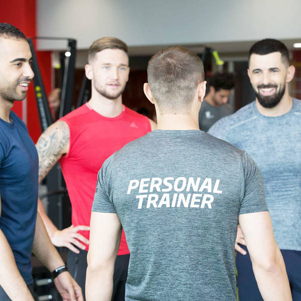 Fitness First members having a conversation with a personal trainer Fitness First members having a conversation with a personal trainer