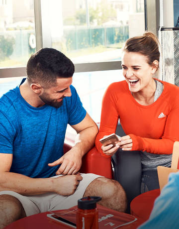 two Fitness First members laughing two Fitness First members laughing