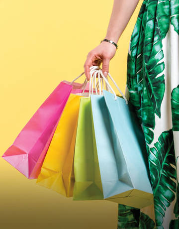 Lady holding bags after shopping using Good Vibes app Lady holding bags after shopping using Good Vibes app