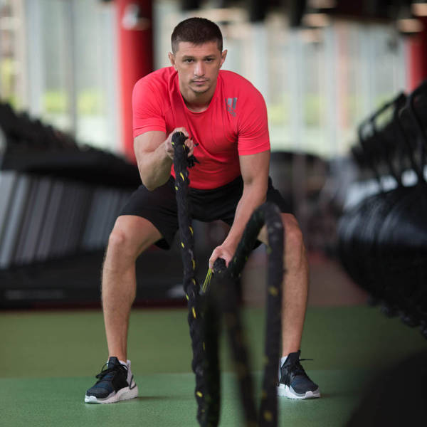 Athlete performing battle rope exercise Athlete performing battle rope exercise