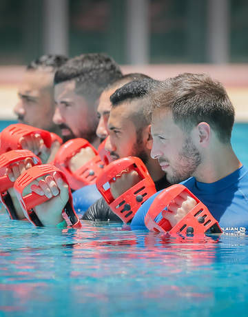 Pool Classes Men exercising in swimming pool