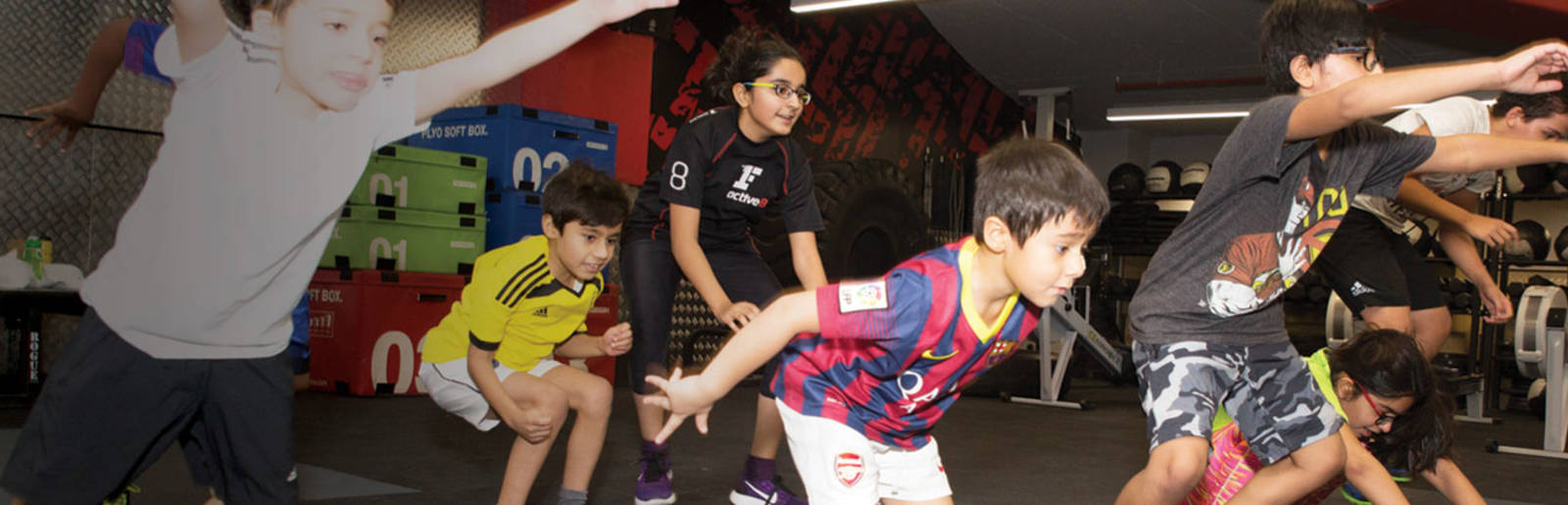 group of kids jumping in a Fitness First Xfit class